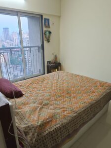 spacious bedroom of 1 bhk flat in thane